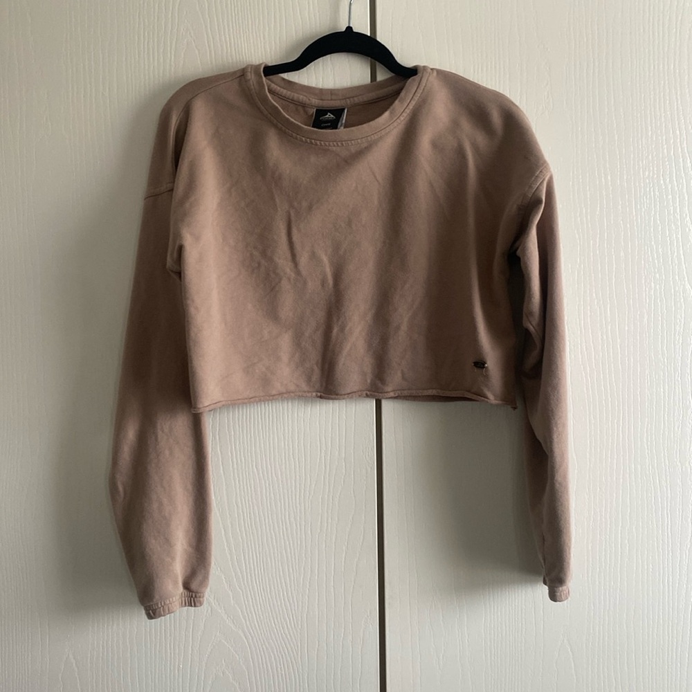 This is a small cropped tan sweatshirt with scrunched ends of sleeves.